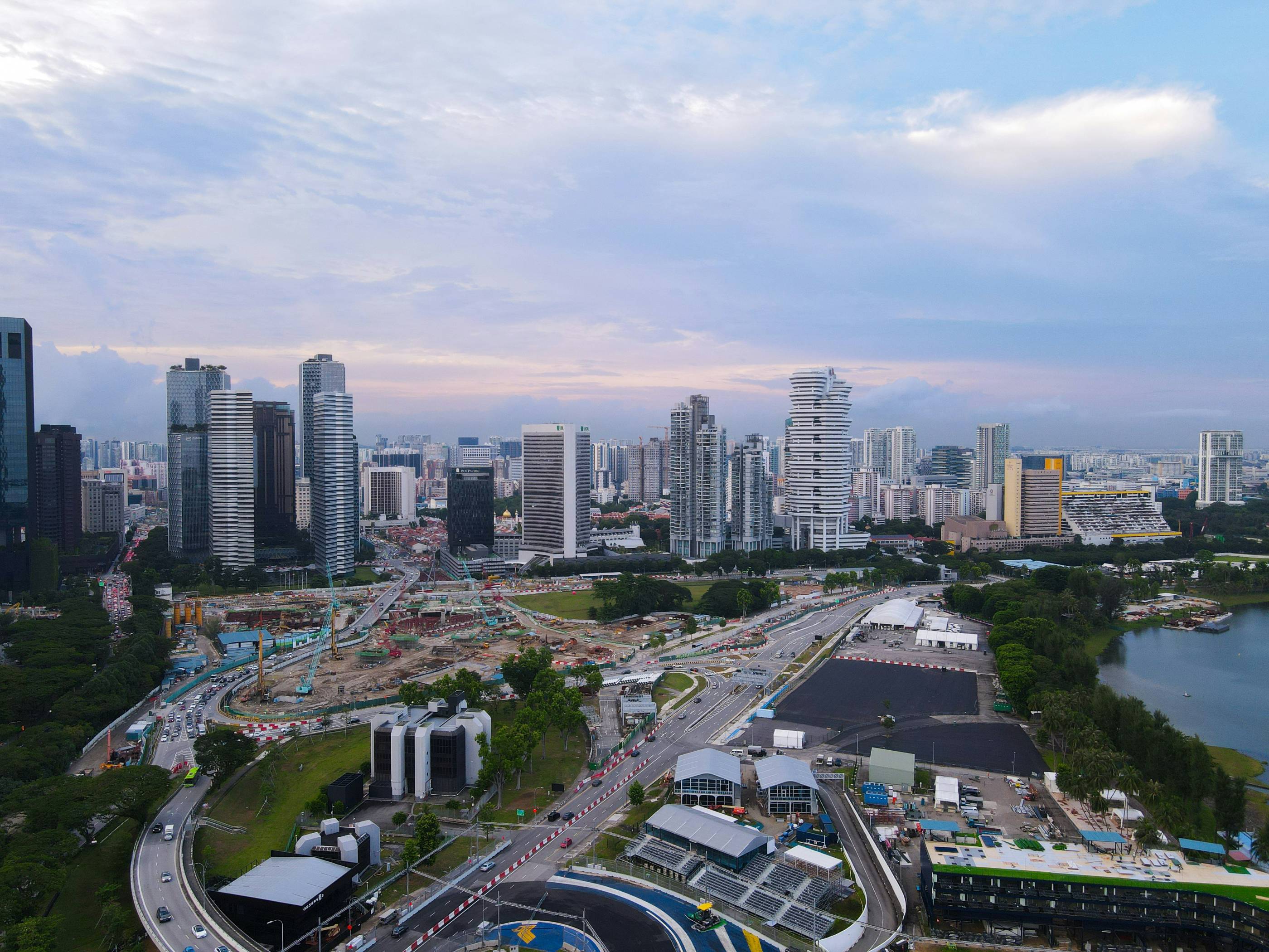 Modern cityscape with skyscrapers and construction sites.